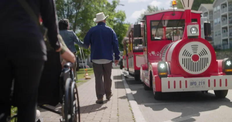 Red trackless tourist train along downtown Corner Brook