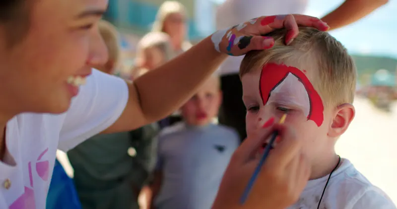 Family face-painting at a Corner Brook waterfront community event