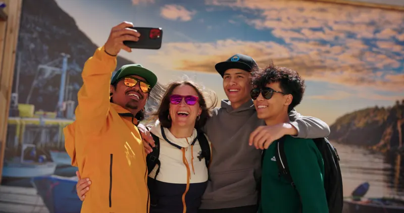 Friends taking a golden-hour selfie along the Bay of Islands coast