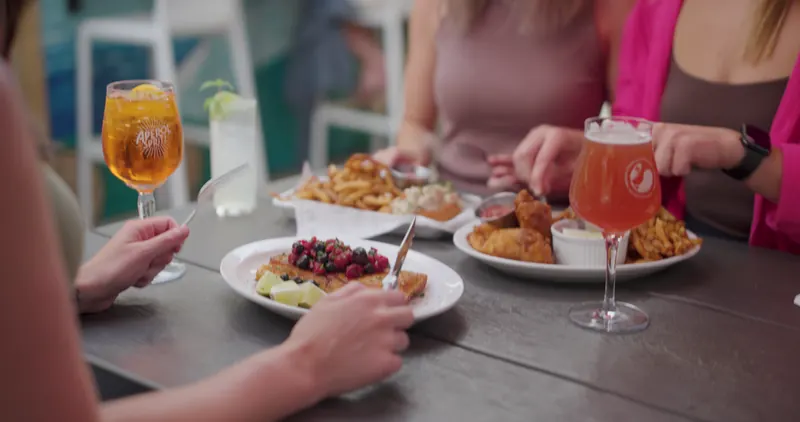 Outdoor patio dining with local fish, berry compote, and craft drinks